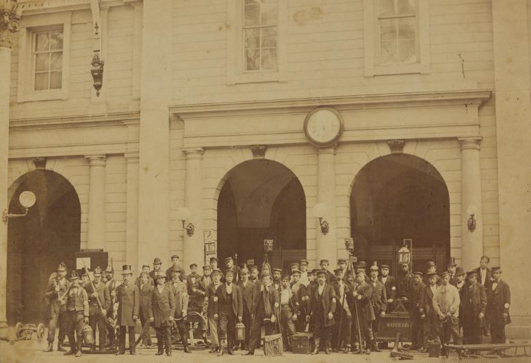 Groepsfoto van vrijwillige brandweermannen voor De Beurs in 1878. Collectie Vroege Foto's. NL-RtSA_4187_RI-1707
